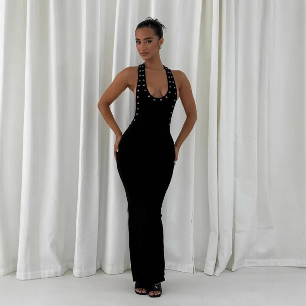 Full body view of a woman in a halter neck studded side cutout maxi dress