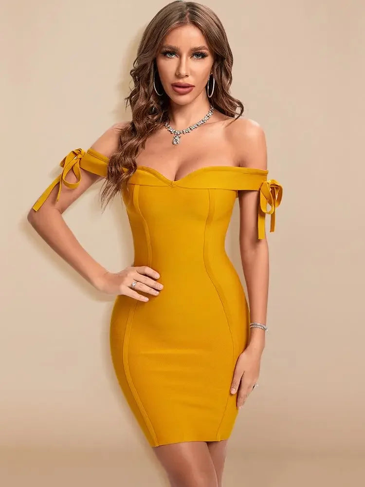 Woman wearing a mustard yellow off-shoulder dress against a beige background
