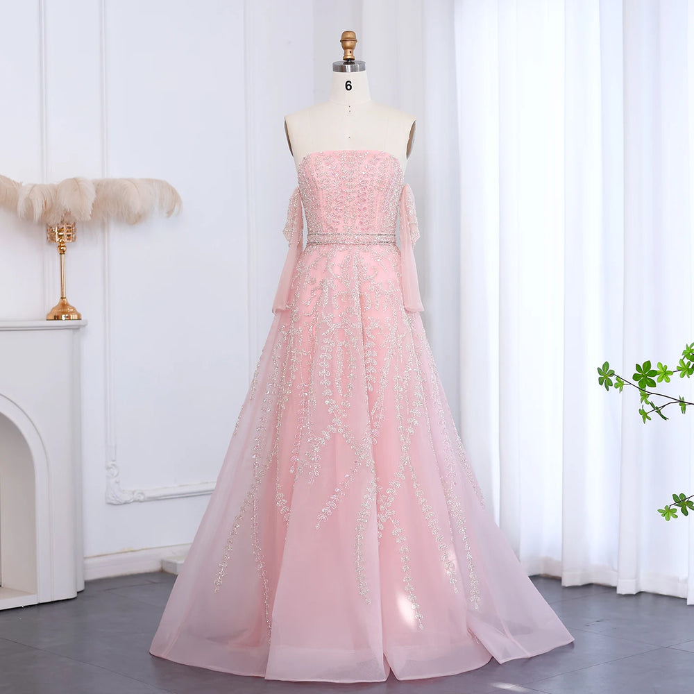 Pink evening gown on a mannequin against a white curtain background