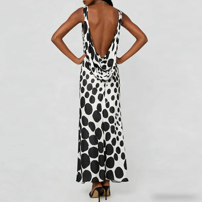 Back view of a dot print sleeveless maxi dress with open cowl back