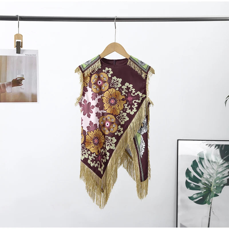 Decorative vest with floral patterns and fringes on a hanger against a white background.