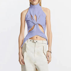 Woman wearing a purple halter top with cut-out design on a white background