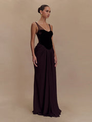 Woman wearing a black evening gown against a beige background