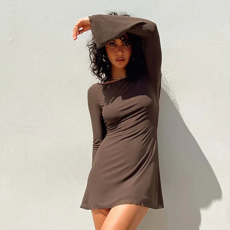 Woman wearing a brown dress against a light background