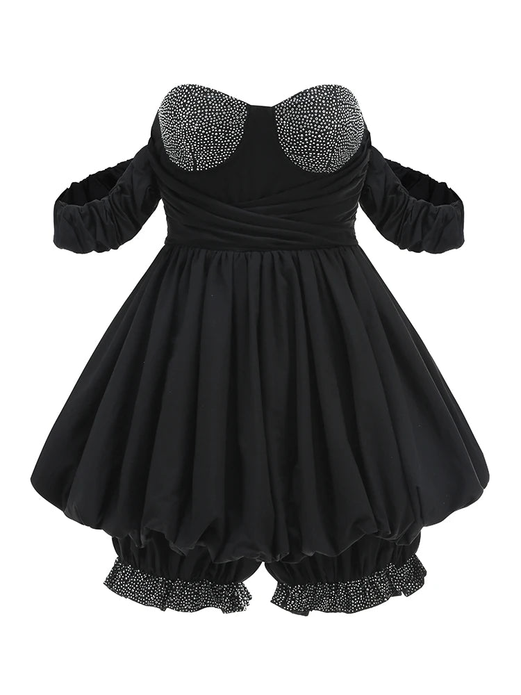 Black dress with embellished collar and hem on a white background