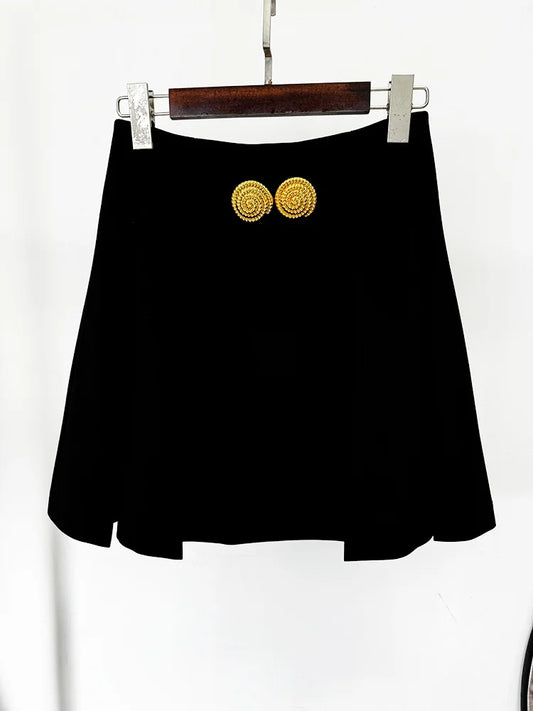 Black pleated mini skirt hanging on a hanger
