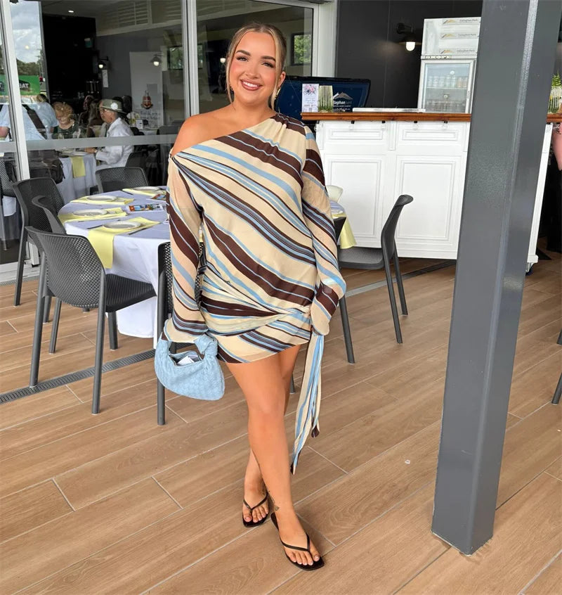 Striped one-shoulder mini dress worn by a model