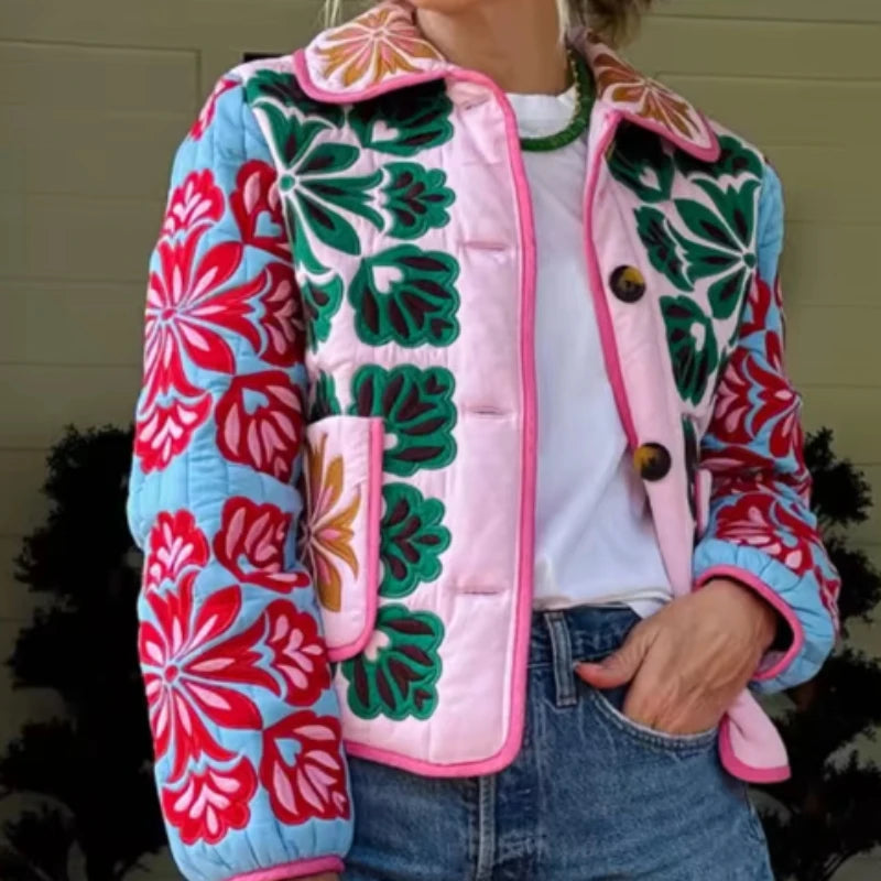 Floral print quilted jacket with contrasting panels and pocket detail.