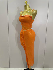 Orange dress on a mannequin against a plain background