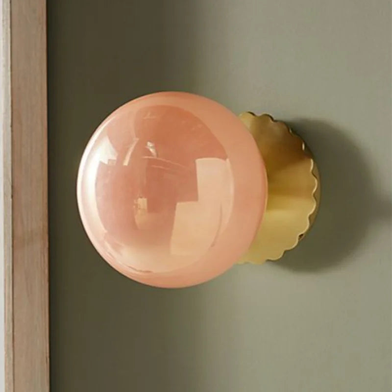  A close-up of the Golden Atelier Modern Pink Glass Wall Sconce, showcasing its intricate glasswork and sleek design. A