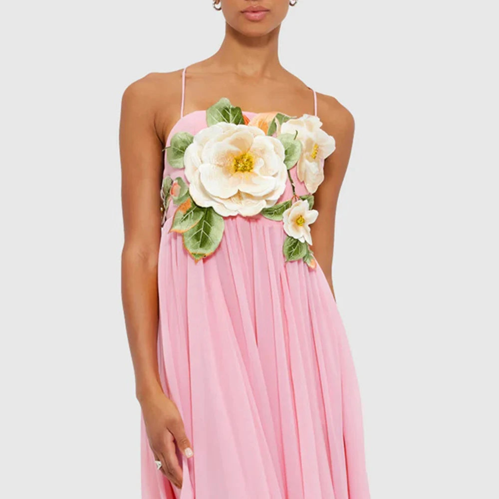 Pink dress with floral embellishments on a plain background