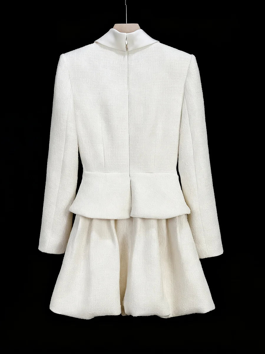White jacket and skirt set on a black background