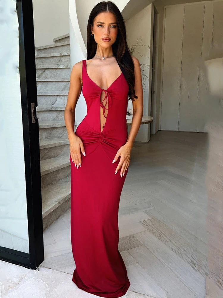 Woman in a red dress standing in a modern interior setting