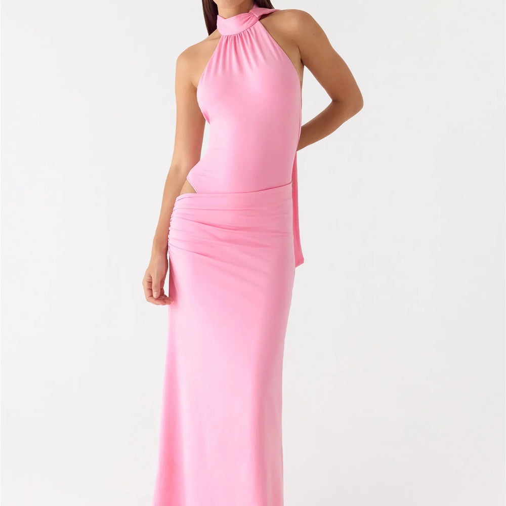 Pink halter neck dress on a white background