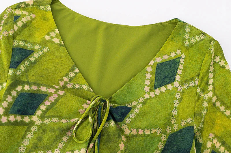 Close-up of the V-neck and tie-front detail on the midi dress.