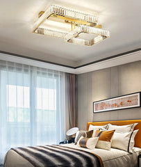 Modern bedroom with a ceiling light fixture, bed, and wall art.