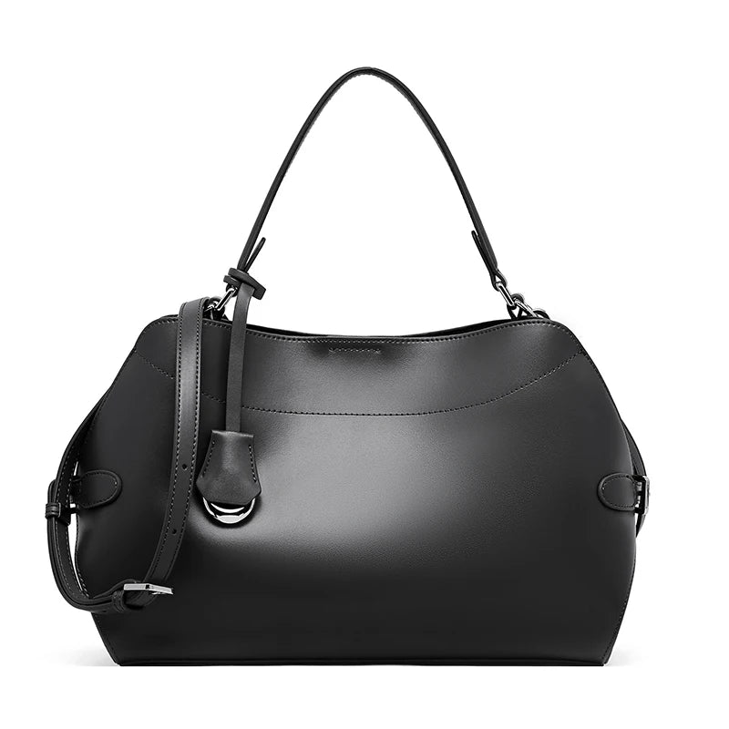 Black handbag with a strap on a white background