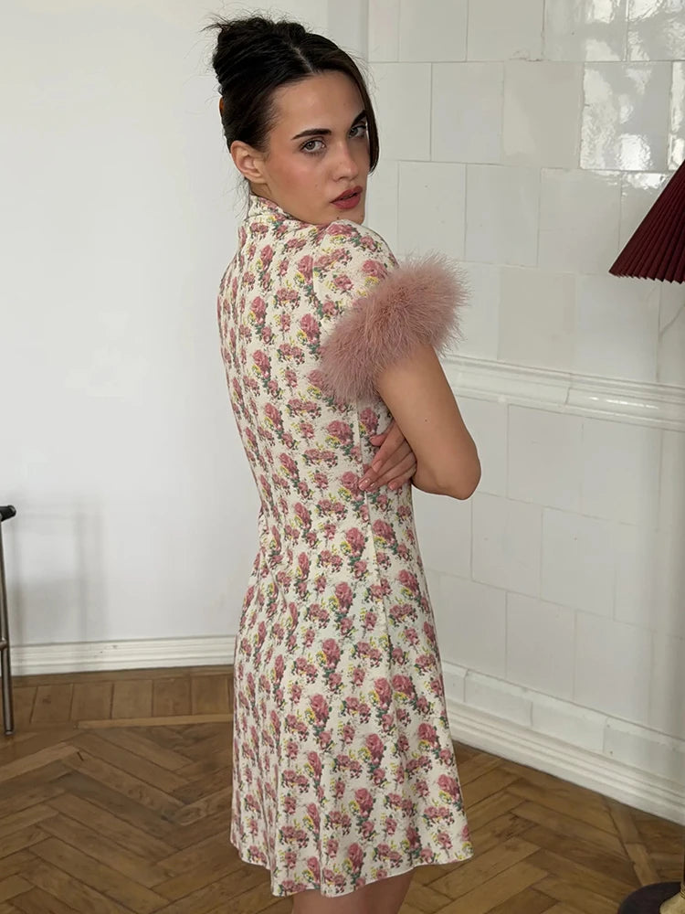 Woman wearing a floral dress with fluffy sleeves in an indoor setting.