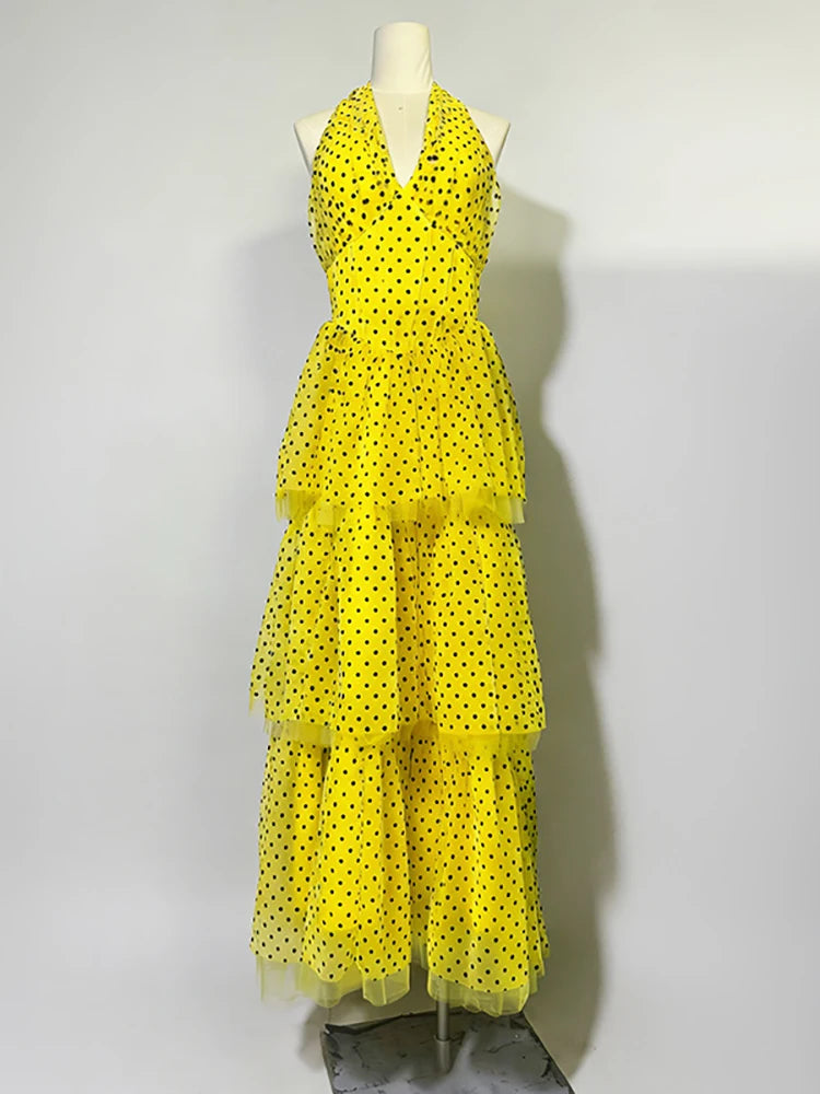 Yellow polka dot dress on a mannequin against a white background