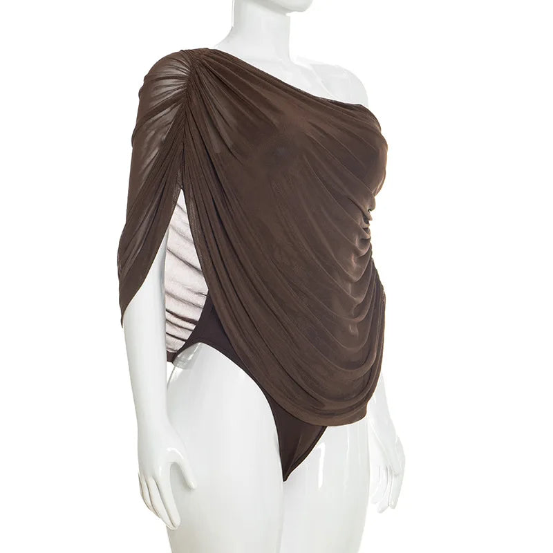Brown draped top on a mannequin against a white background