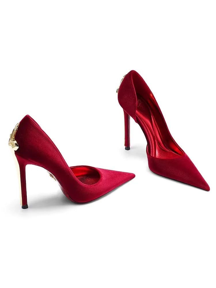 Pair of red high-heeled shoes on a white background