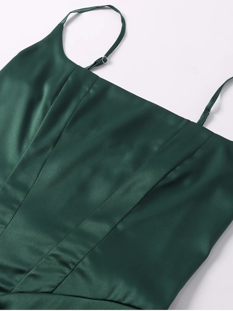Green satin dress with thin straps on a white background