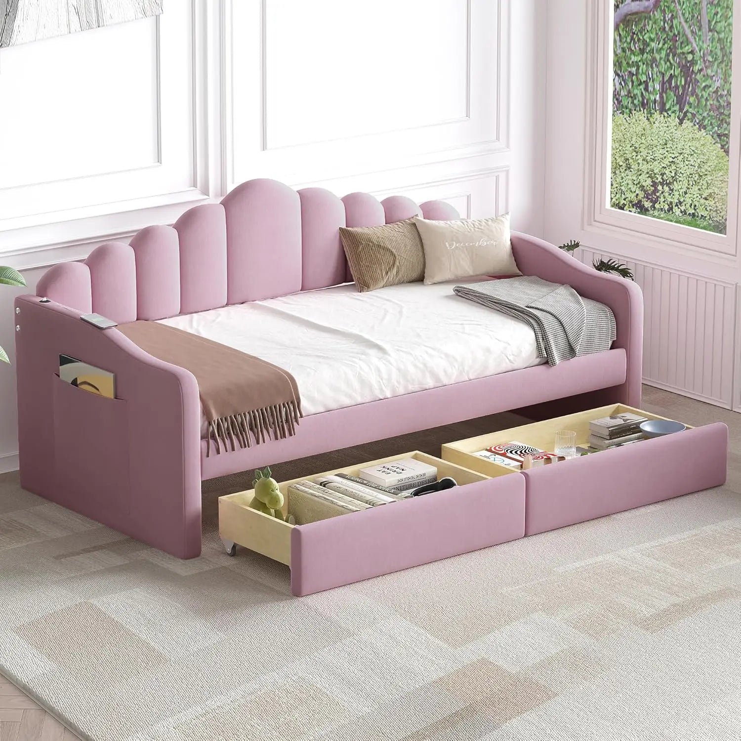 Pink twin upholstered daybed with drawers and USB ports.