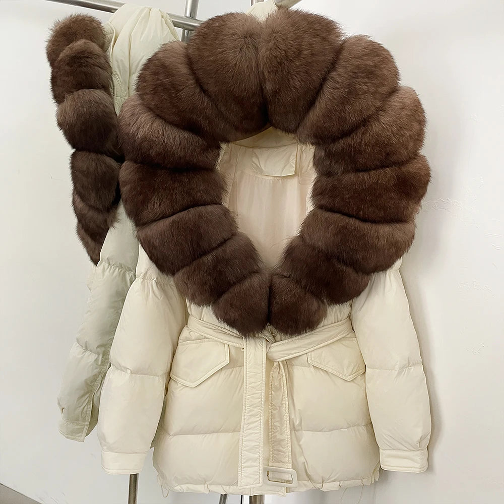 White puffer coat with a large brown fur collar on a mannequin 