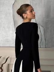 A woman wearing a black pleated patchwork maxi dress with long sleeves, showcasing its unique design. Golden Atelier 4