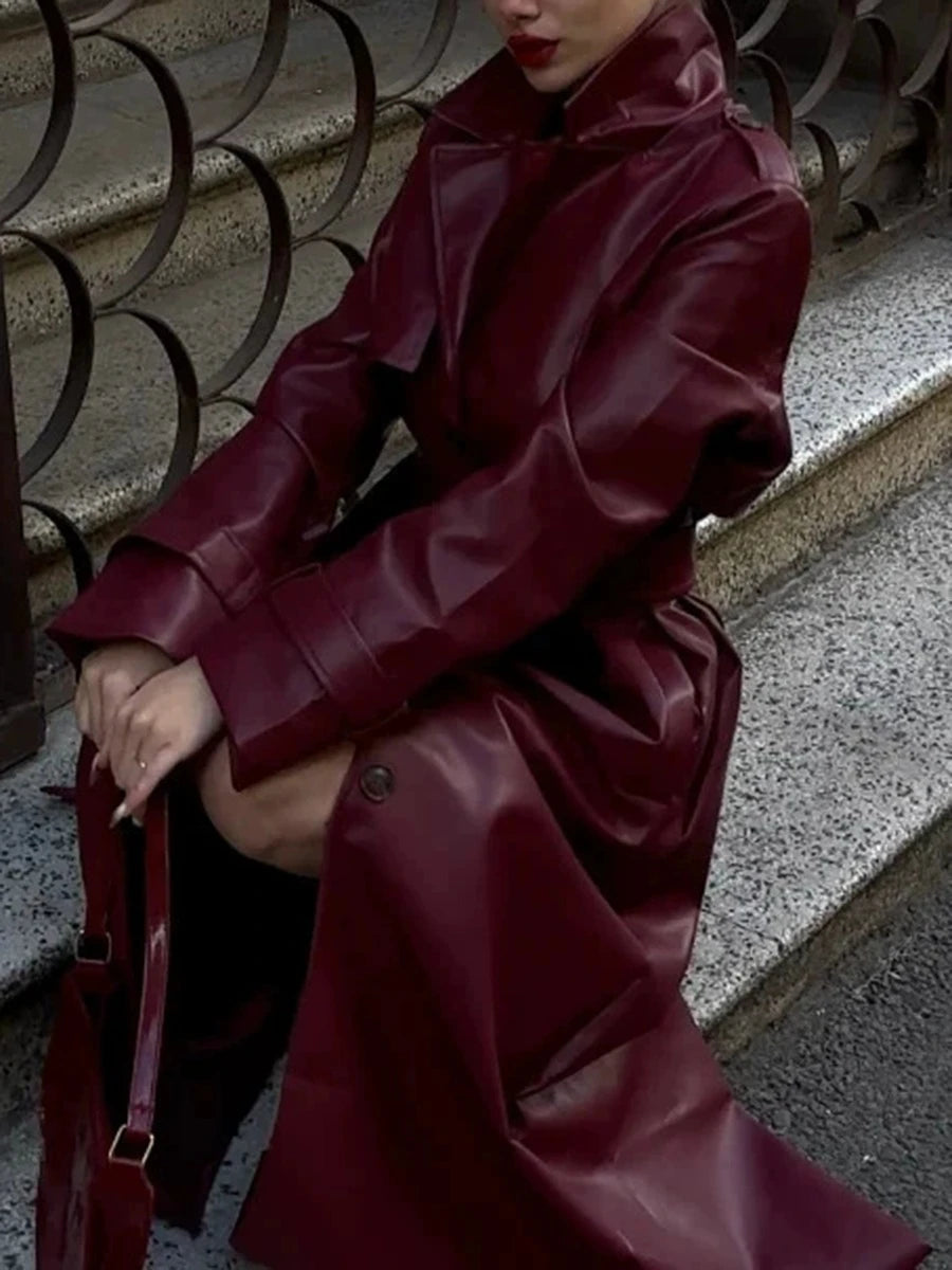 Close-up of burgundy faux leather trench coat details