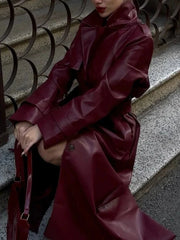 Close-up of burgundy faux leather trench coat details