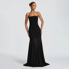 Black strapless gown on a model against a white background
