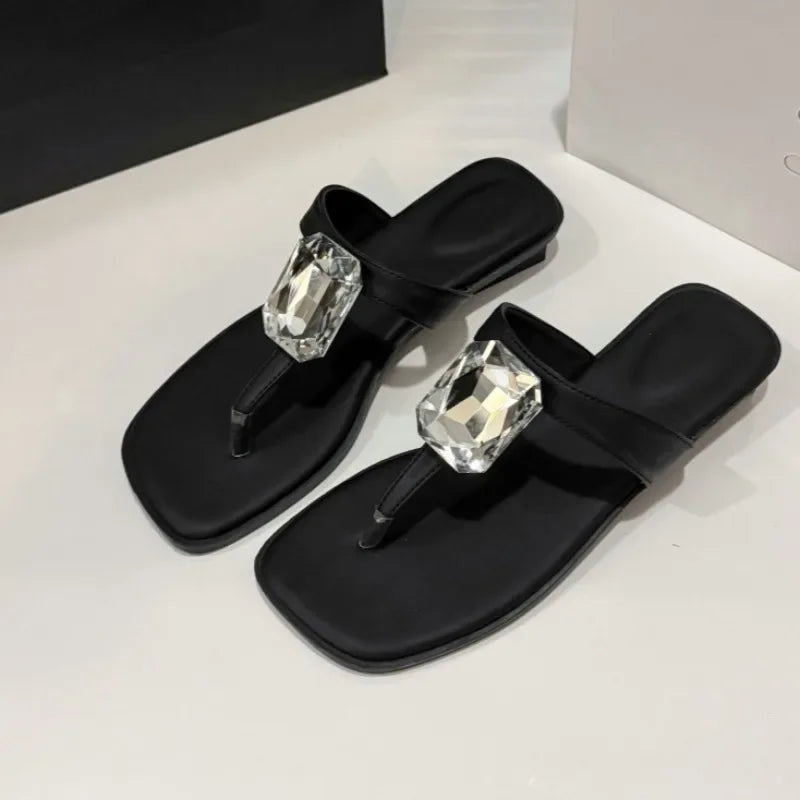 Black square toe flat sandals showcasing the crystal detail and soft sole.