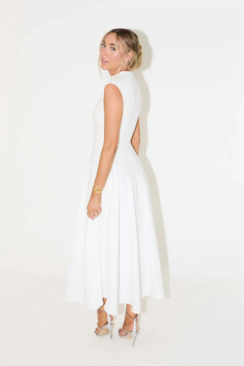 Woman wearing a white sleeveless dress with a cutout design on a white background