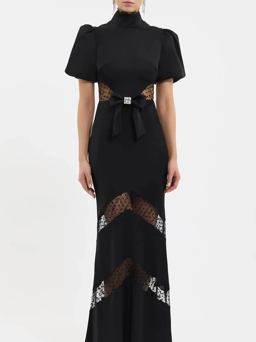 Detail of lace paneling on black puff sleeve maxi dress