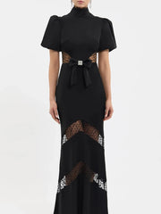 Detail of lace paneling on black puff sleeve maxi dress