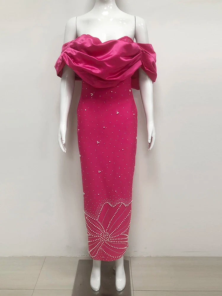 Mannequin wearing a pink evening gown with a draped top on a white background