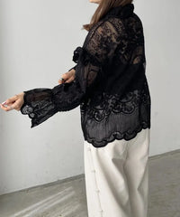 Women's lace top with embroidery and a strap detail.