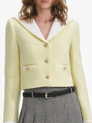 Light yellow blazer with white collar and black plaid skirt 