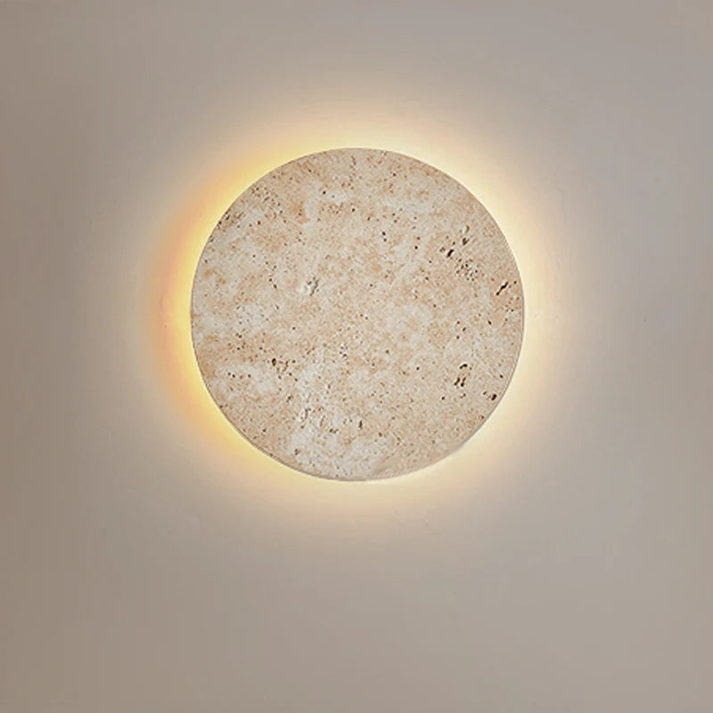  Natural yellow cave stone LED sconce with a warm glow, mounted on a bedroom wall. Golden Atelier 