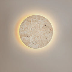  Natural yellow cave stone LED sconce with a warm glow, mounted on a bedroom wall. Golden Atelier 