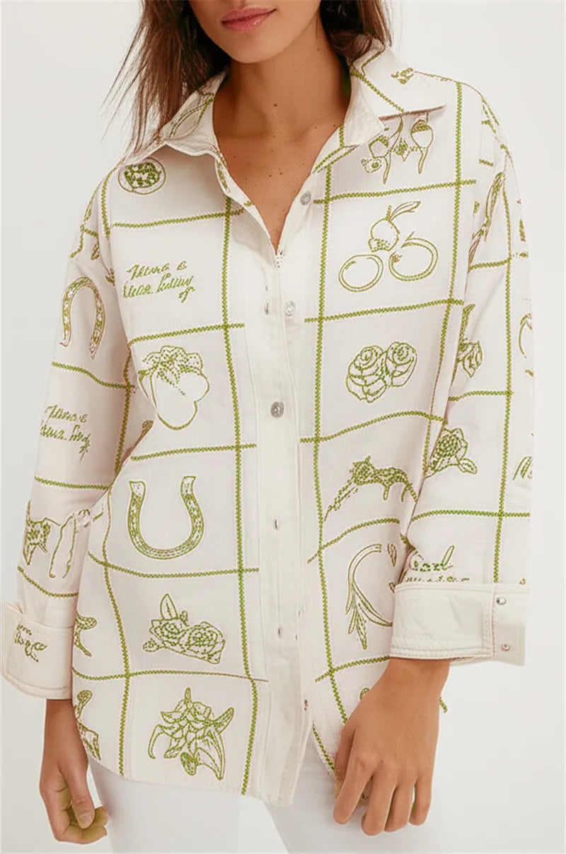 White shirt with green embroidery and text 