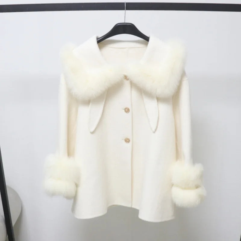White coat with fur trim on a hanger against a white background
