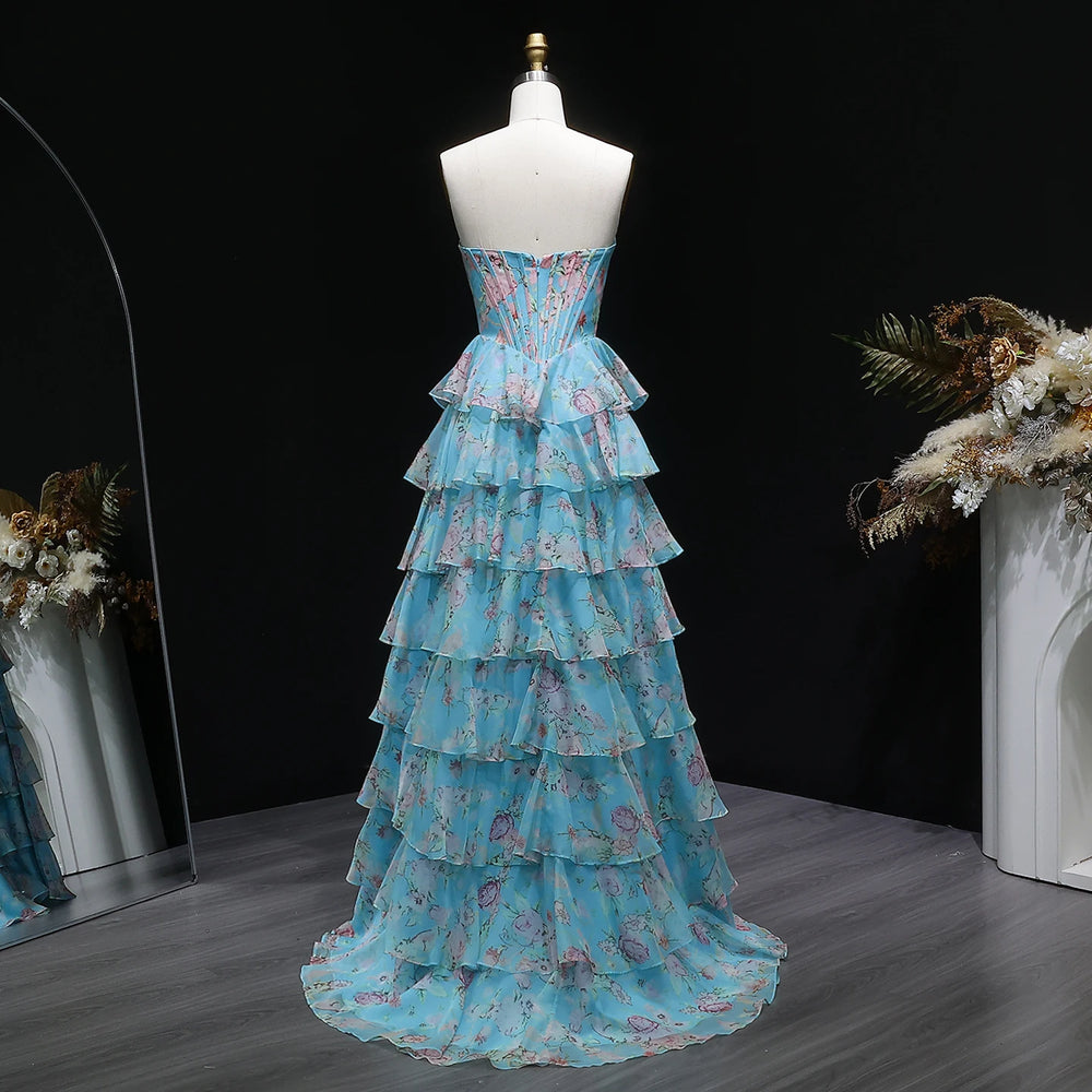 Blue floral dress on a mannequin against a black background