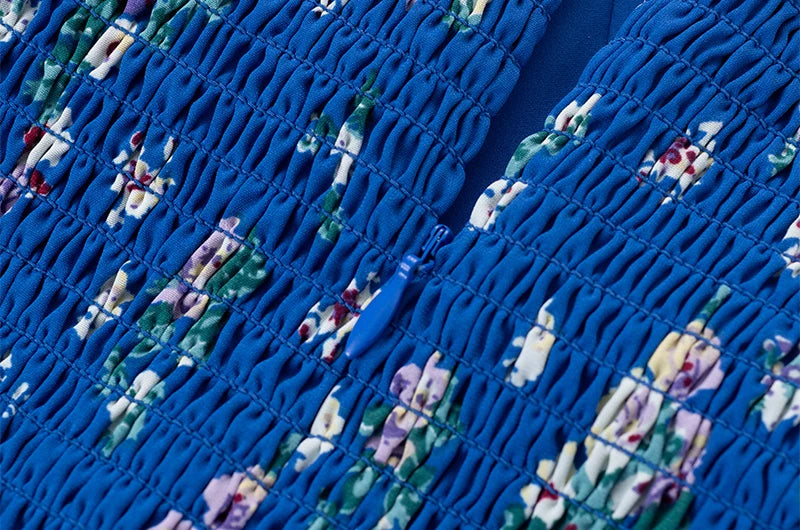 Close-up of smocked back detail and zipper on floral midi dress