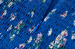 Close-up of smocked back detail and zipper on floral midi dress