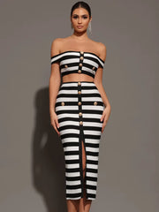 Woman wearing a black and white striped outfit with button details on a gray background