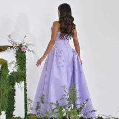 A model wearing the lilac pearl A-line evening gown, showcasing its elegant silhouette and flowing skirt. Golden Atelier 10