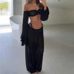 Black off shoulder ruffle crop top and wide leg pants set in bathroom