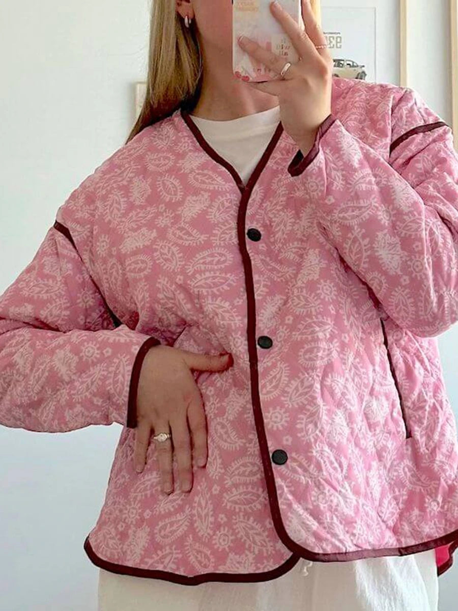 Quilted jacket with pink paisley print, hand in pocket